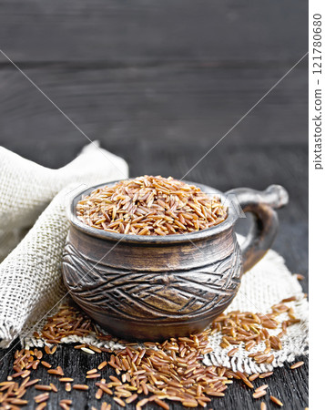 Rice red in cup on black board 121780680