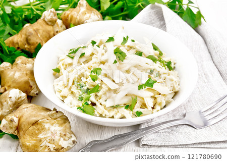 Salad of Jerusalem artichoke and eggs in plate on board Salad of Jerusalem artichoke and eggs in plate on board 121780690