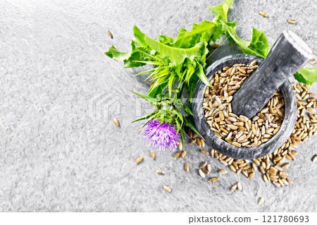 Seeds milk thistle in mortar on granite table top Seeds milk thistle in mortar on granite table top 121780693