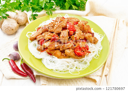 Stir-fry of chicken with peppers in plate on board Stir-fry of chicken with peppers in plate on board 121780697