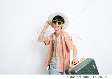 Smiling man in summer hat and sunglasses posing with a suitcase against white background Smiling man in summer hat and sunglasses posing with a suitcase against white background 121781039