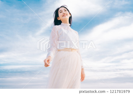 Woman portrait on blue sky background 121781979