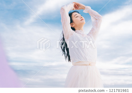 Woman portrait on blue sky background Woman portrait on blue sky background 121781981