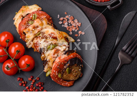 Rings of eggplant, tomato and zucchini with pieces of chicken and garlic 121782352