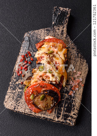 Rings of eggplant, tomato and zucchini with pieces of chicken and garlic Rings of eggplant, tomato and zucchini with pieces of chicken and garlic 121782361
