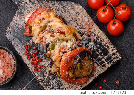 Rings of eggplant, tomato and zucchini with pieces of chicken and garlic Rings of eggplant, tomato and zucchini with pieces of chicken and garlic 121782363