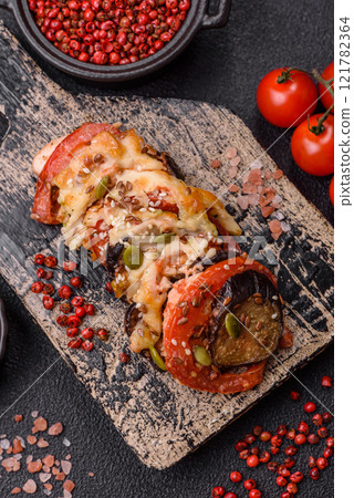 Rings of eggplant, tomato and zucchini with pieces of chicken and garlic Rings of eggplant, tomato and zucchini with pieces of chicken and garlic 121782364