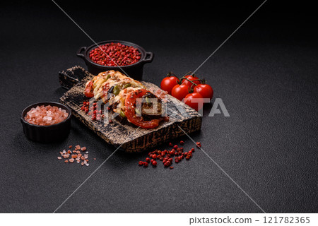 Rings of eggplant, tomato and zucchini with pieces of chicken and garlic Rings of eggplant, tomato and zucchini with pieces of chicken and garlic 121782365