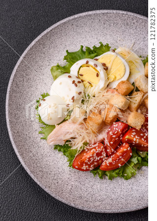 Delicious fresh salad with lettuce, croutons, chicken fillet, tomatoes and egg Delicious fresh salad with lettuce, croutons, chicken fillet, tomatoes and egg 121782375