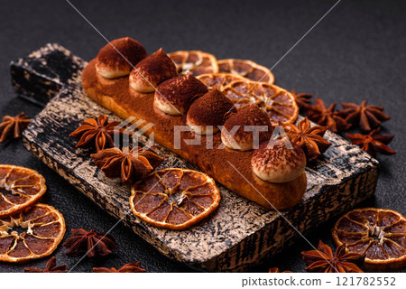 Sweet eclair with chocolate custard sprinkled with cocoa powder Sweet eclair with chocolate custard sprinkled with cocoa powder 121782552