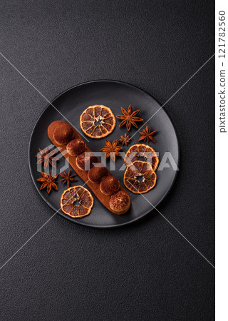 Sweet eclair with chocolate custard sprinkled with cocoa powder Sweet eclair with chocolate custard sprinkled with cocoa powder 121782560