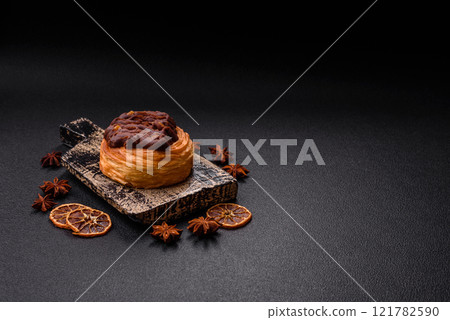 Sweet dessert danish covered with chocolate cream, with cream filling Sweet dessert danish covered with chocolate cream, with cream filling 121782590