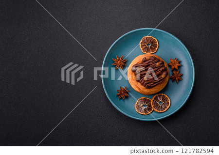 Sweet dessert danish covered with chocolate cream, with cream filling 121782594