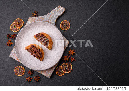 Sweet dessert danish covered with chocolate cream, with cream filling Sweet dessert danish covered with chocolate cream, with cream filling 121782615