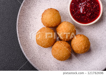 French fries balls with breaded brie or camembert cheese with sweet berry sauce 121782696