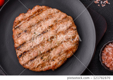 Juicy grilled beef or pork steak with salt, spices and herbs 121782870