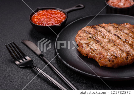 Juicy grilled beef or pork steak with salt, spices and herbs 121782872