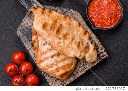 Delicious fresh grilled chicken fillet with spices and herbs Delicious fresh grilled chicken fillet with spices and herbs 121782917