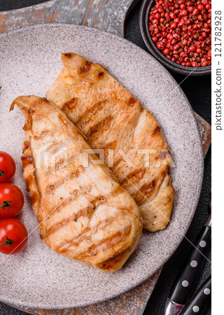 Delicious fresh grilled chicken fillet with spices and herbs Delicious fresh grilled chicken fillet with spices and herbs 121782928