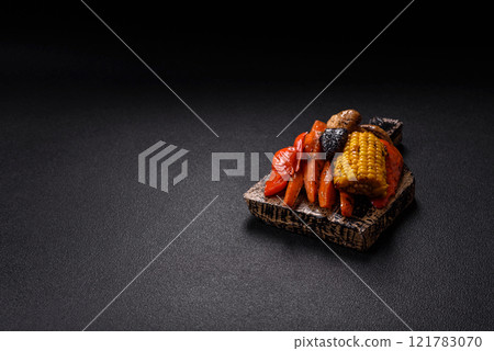 Grilled vegetables peppers, tomatoes, zucchini, onions, carrots, corn, mushrooms 121783070