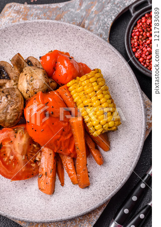 Grilled vegetables peppers, tomatoes, zucchini, onions, carrots, corn, mushrooms 121783089