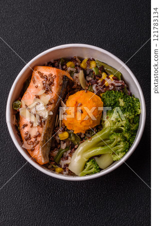 Grilled salmon with salt and spices, broccoli, tomatoes, rice 121783134