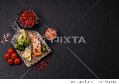 Grilled salmon with salt and spices, broccoli, tomatoes, rice 121783148