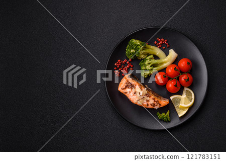 Grilled salmon with salt and spices, broccoli, tomatoes, rice 121783151