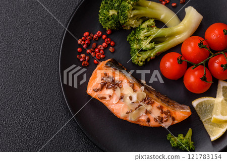 Grilled salmon with salt and spices, broccoli, tomatoes, rice 121783154