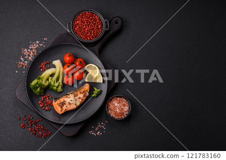 Grilled salmon with salt and spices, broccoli, tomatoes, rice 121783160