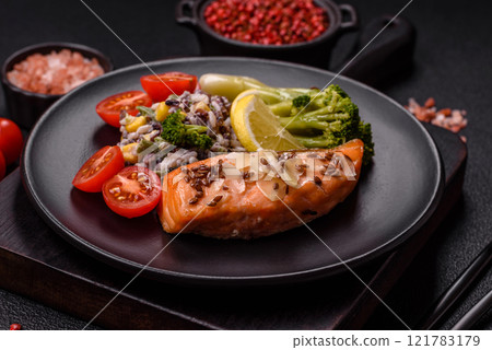 Grilled salmon with salt and spices, broccoli, tomatoes, rice 121783179