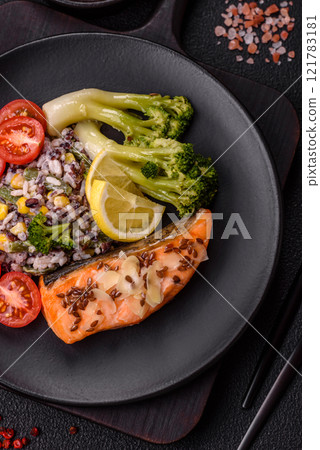 Grilled salmon with salt and spices, broccoli, tomatoes, rice 121783181