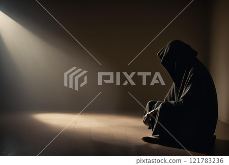 Depressed person wearing a hoodie in a dark room 121783236