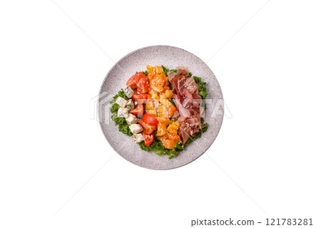 Appetizing salad with prosciutto, pumpkin, cheese and tomatoes 121783281