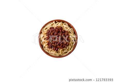 Rice noodles with beans, meat, tomato sauce, spices and herbs 121783393