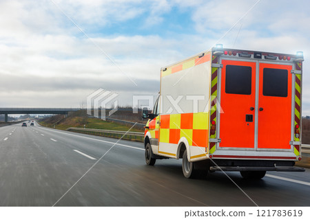 German Ambulance EMS eu uk paramedic rescue van transport rushing drive Europe highway road suburb neighborhood sunny day rain. Medical urgent service help vehicle. First aid traffic accident support 121783619