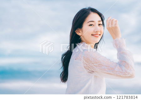 Beauty image of a young woman with blue sky background Beauty image of a young woman with blue sky background 121783814