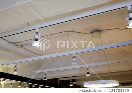 Fluorescent lights on the ceiling of a cafe Fluorescent lights on the ceiling of a cafe 121783839