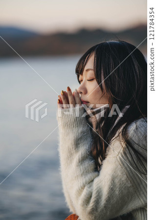 晚上的湖和穿著針織衫和圍巾的年輕女子 121784354