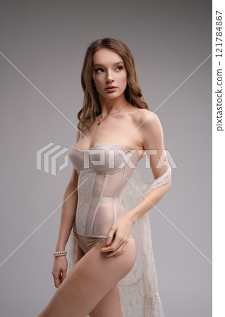 Elegant woman showcasing beauty in corset and lingerie fashion display 121784867
