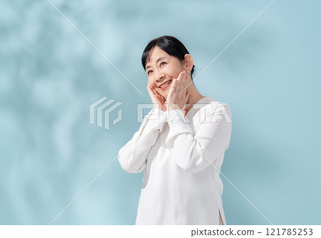 Beauty sunshine filtering through trees Senior woman 121785253