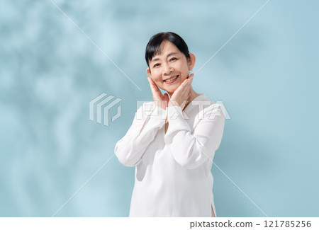 Beauty sunshine filtering through trees Senior woman 121785256