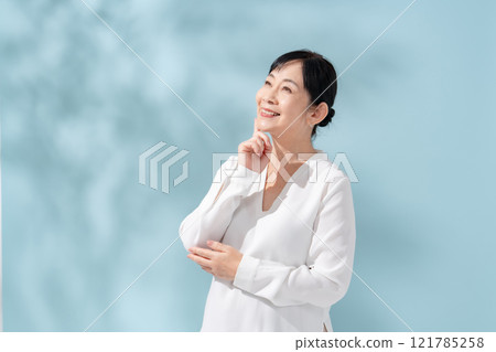 Beauty sunshine filtering through trees Senior woman 121785258