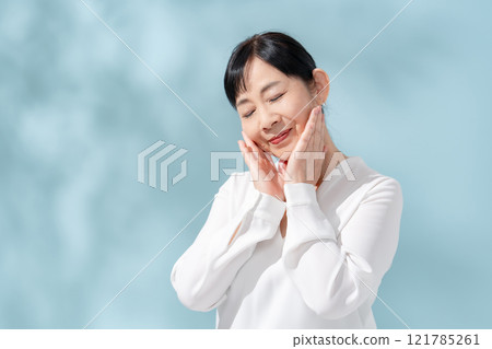 Beauty sunshine filtering through trees Senior woman 121785261