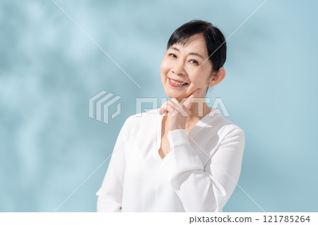 Beauty sunshine filtering through trees Senior woman 121785264