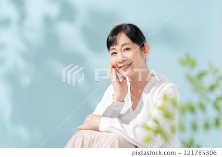 Beauty sunshine filtering through trees Senior woman 121785306