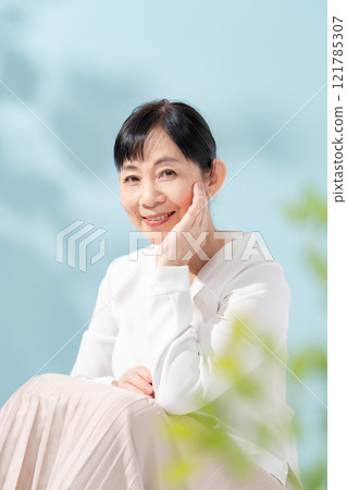 Beauty sunshine filtering through trees Senior woman 121785307