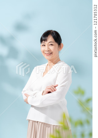 Beauty sunshine filtering through trees Senior woman 121785312