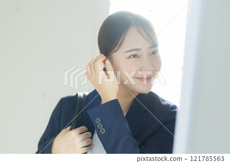 Businesswoman looking in the mirror Businesswoman looking in the mirror 121785563