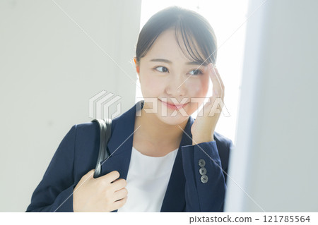 Businesswoman looking in the mirror Businesswoman looking in the mirror 121785564